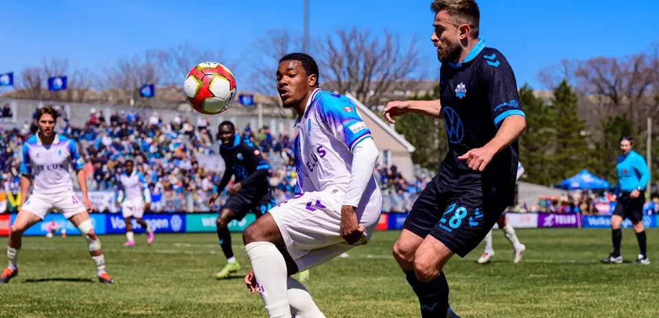 Players competing for the ball during match