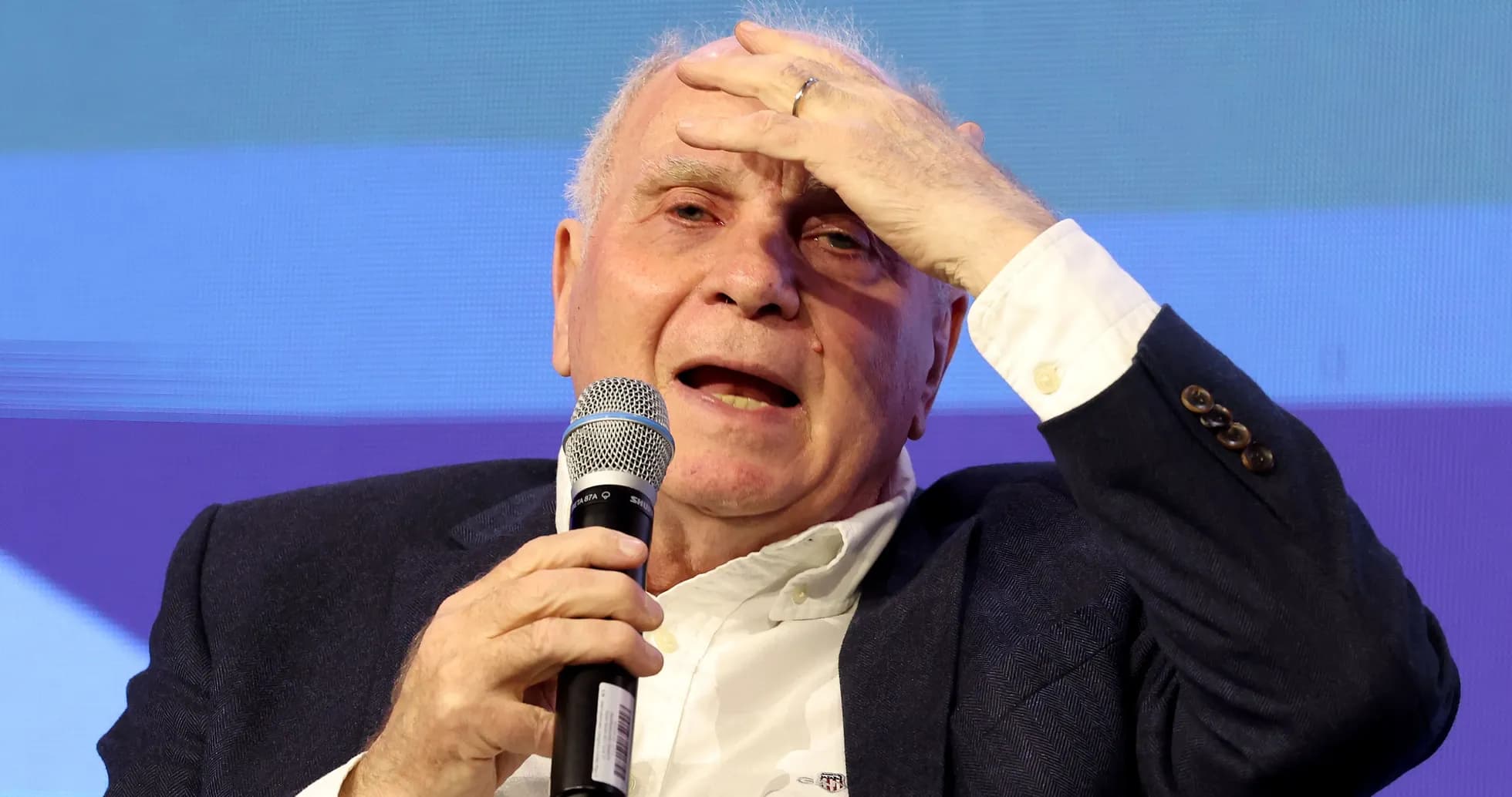 Man speaking into microphone during discussion event