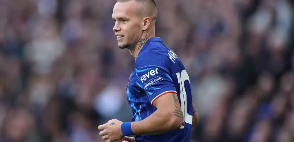 Player in blue jersey running on the field