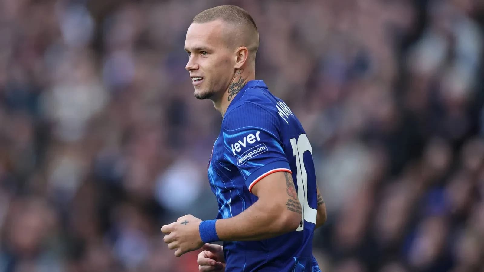 Player in blue jersey running on the field