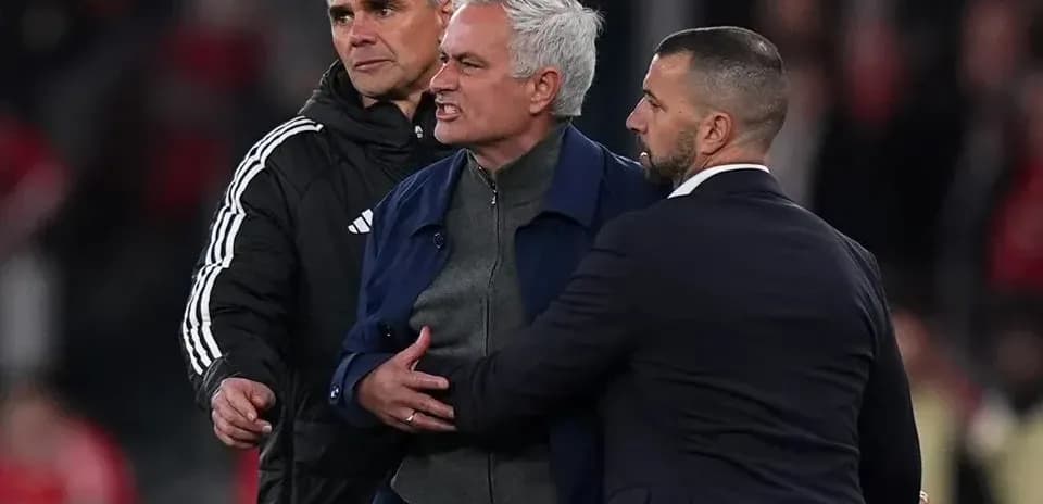 Coach being restrained by staff during heated moment