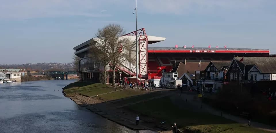 River scene with stadium and people near water