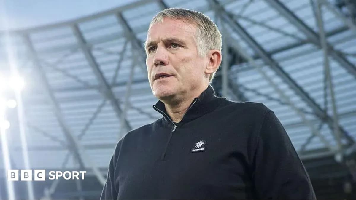 Coach speaking during a press conference at stadium