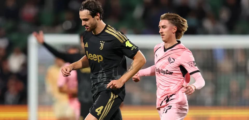 Juventus player running with ball, opponent chasing