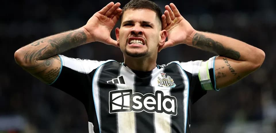 Player celebrating with hands to ears after scoring