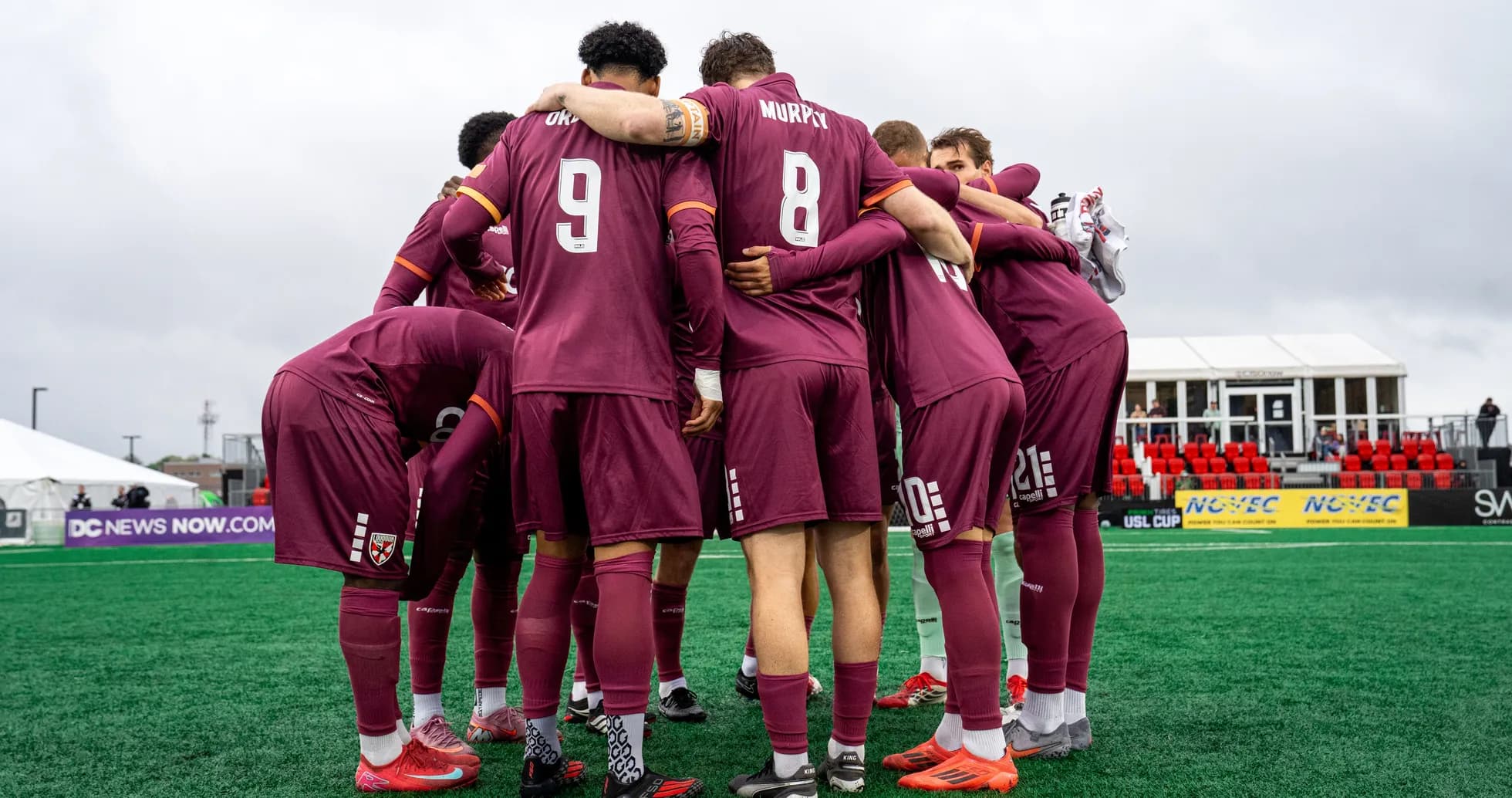 Players huddling before the match