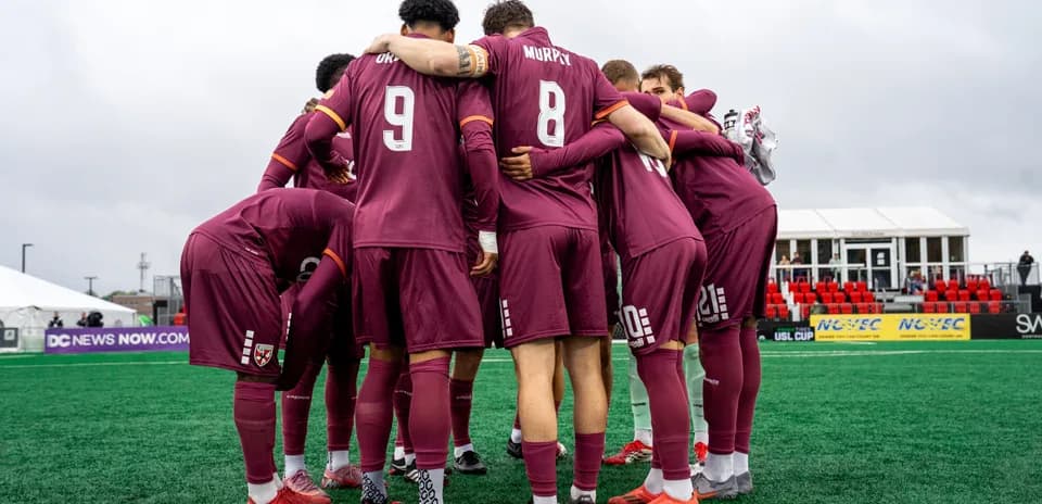 Players huddling before the match