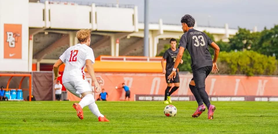 Player 33 dribbling the ball past opponent 12