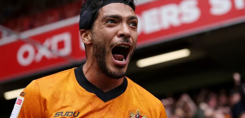 Player celebrating passionately in orange jersey