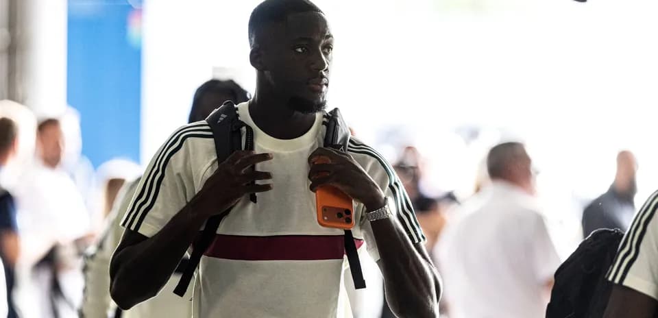Player arriving with backpack and phone in hand