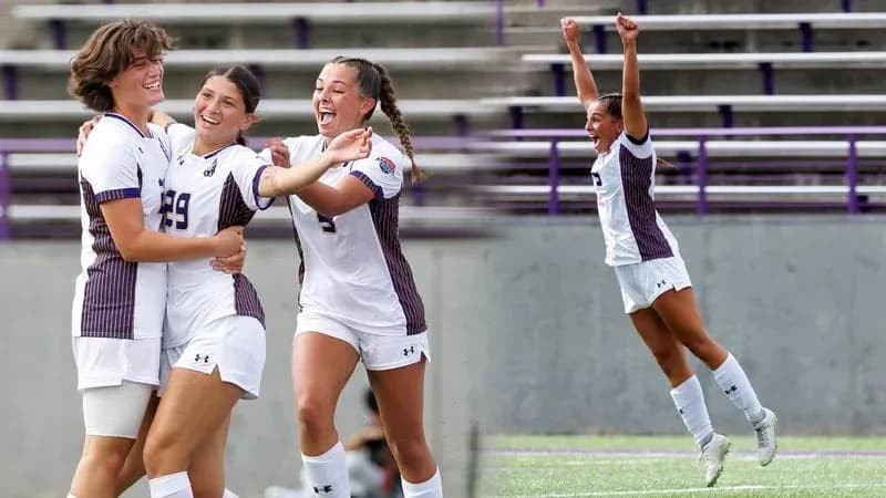 Three soccer players celebrating a goal together