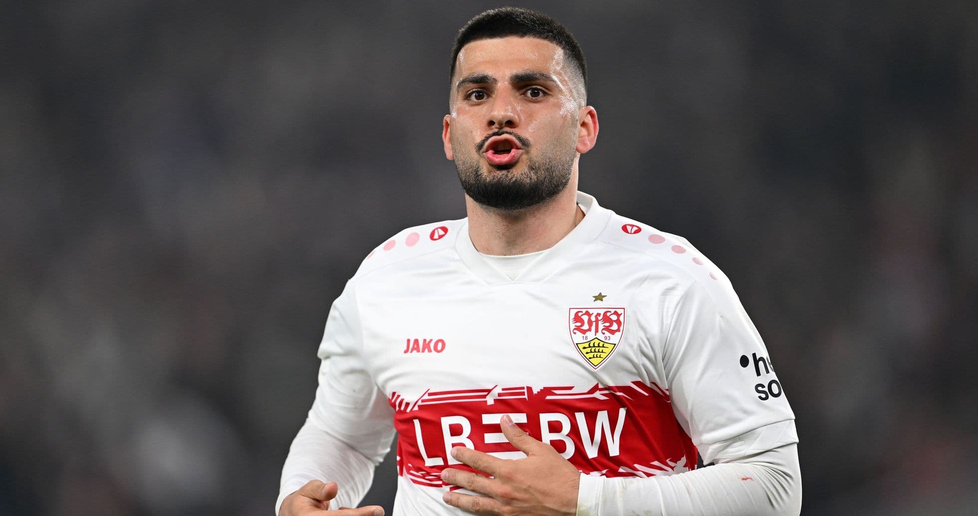 Player celebrating in Stuttgart home jersey during match