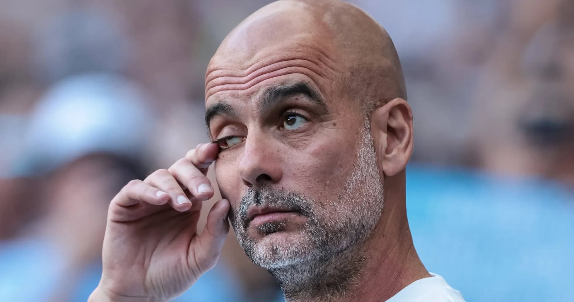 Coach with hand on face during match