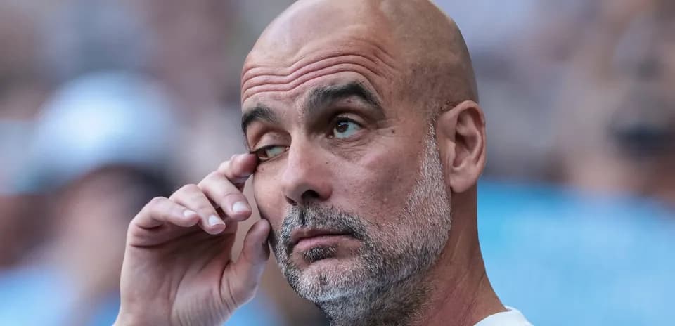 Coach with hand on face during match