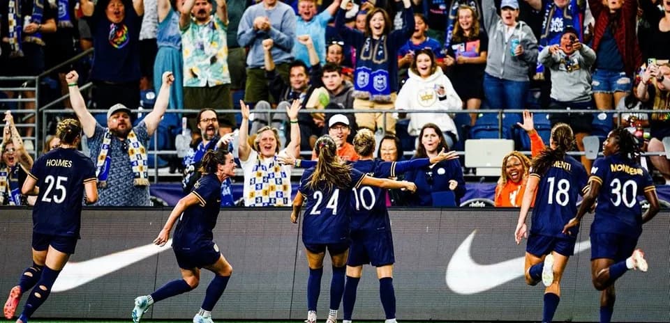 Seattle Reign FC players celebrating a goal