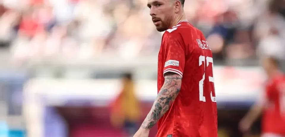 Player wearing red jersey during match action