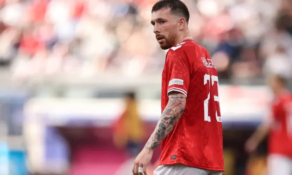Player wearing red jersey during match action