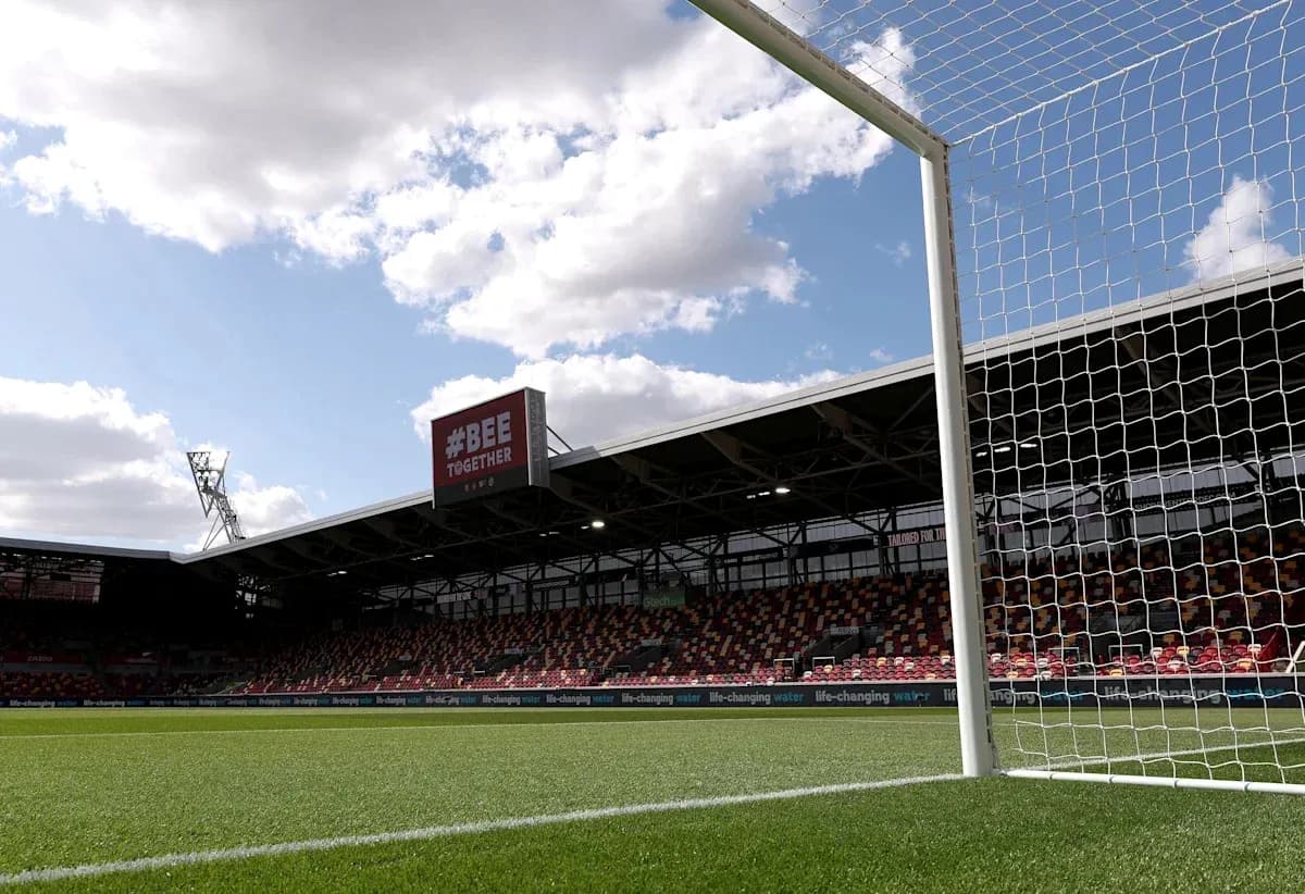 View of goalpost and empty stadium under cloudy sky