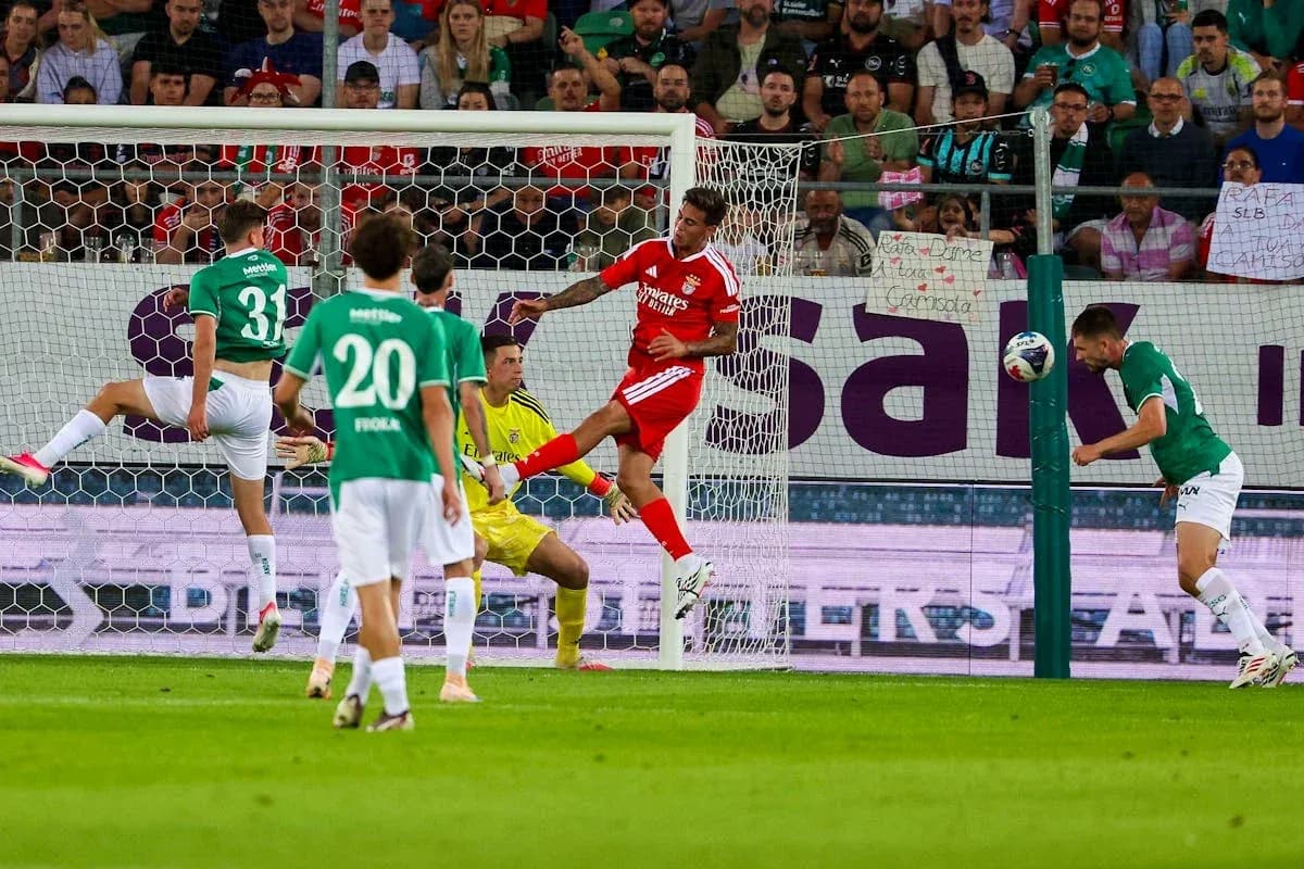 Goalkeeper attempts to block header during match