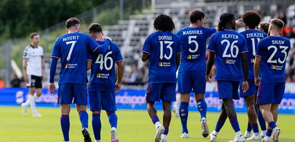 Players celebrating a goal on the field