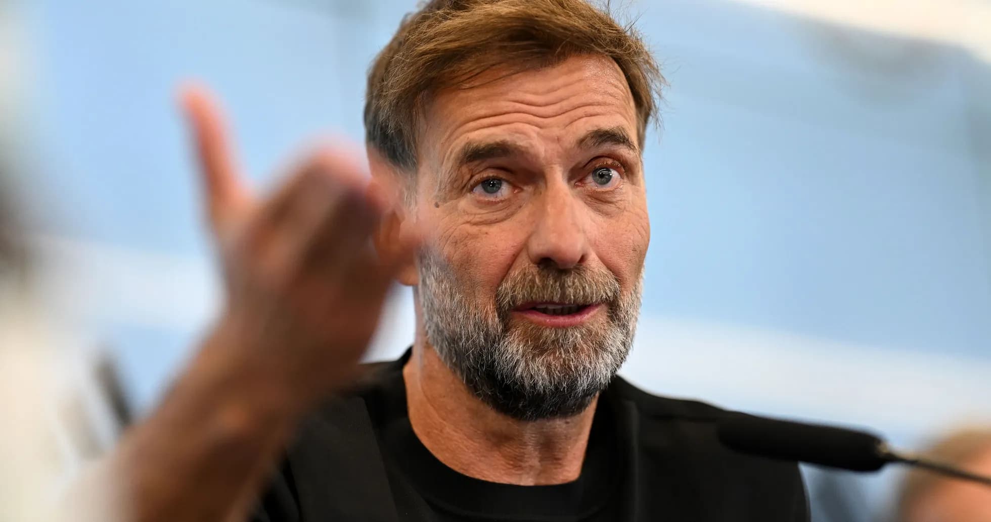 Manager speaking during press conference with microphone