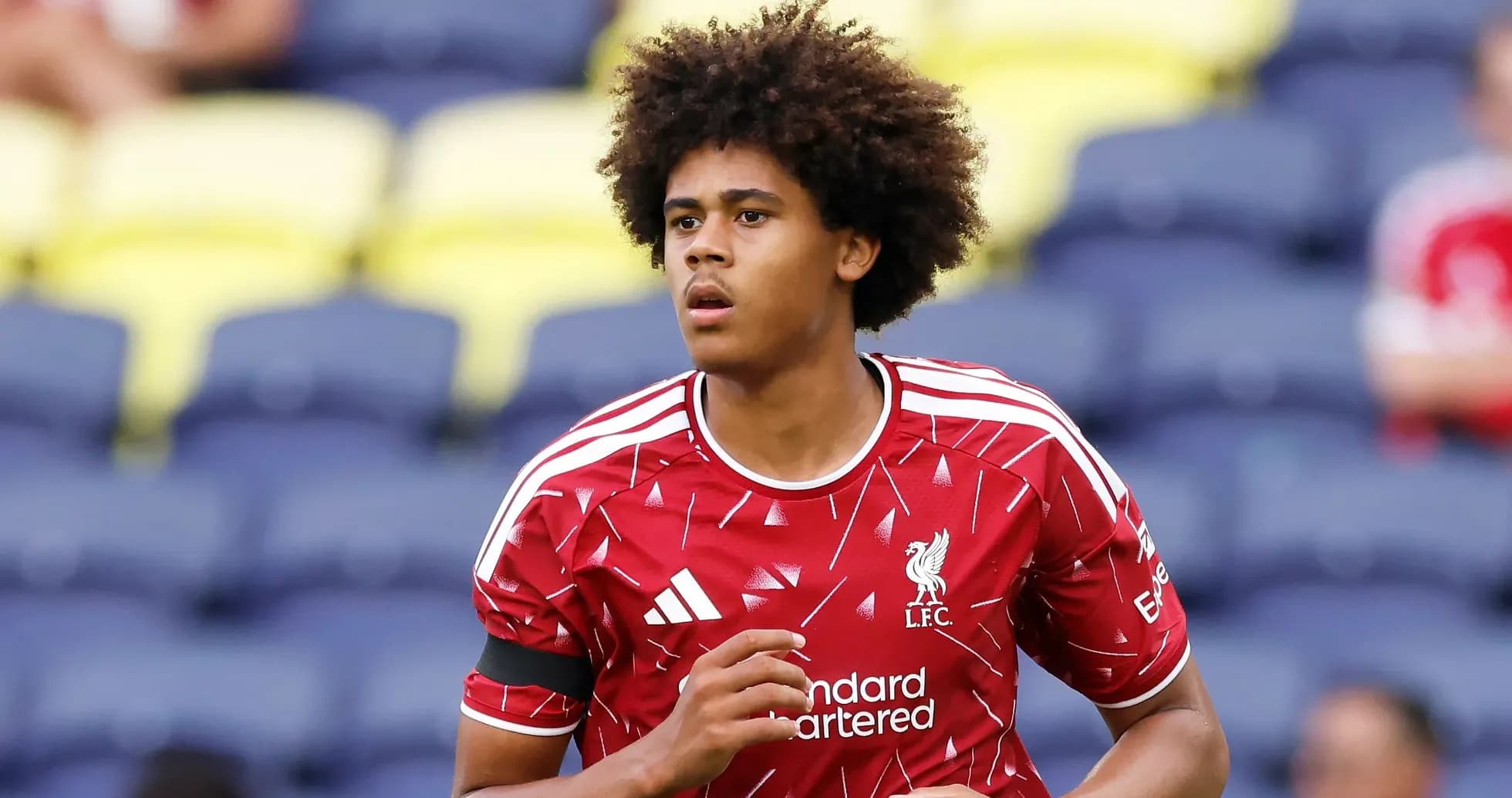 Player warming up in Liverpool kit before match