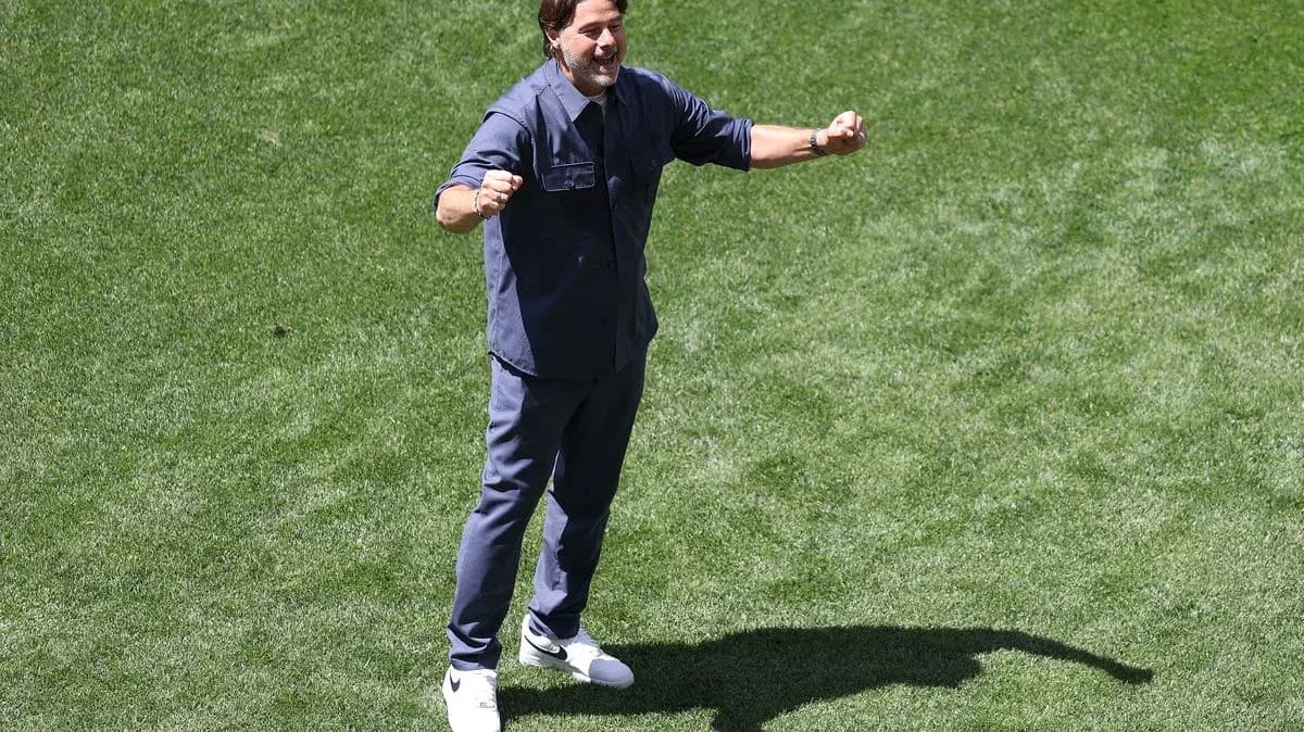 Coach celebrating on the pitch during training session