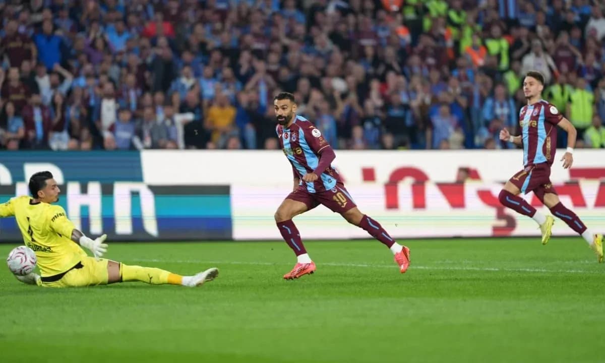 Player scoring past the goalkeeper during match