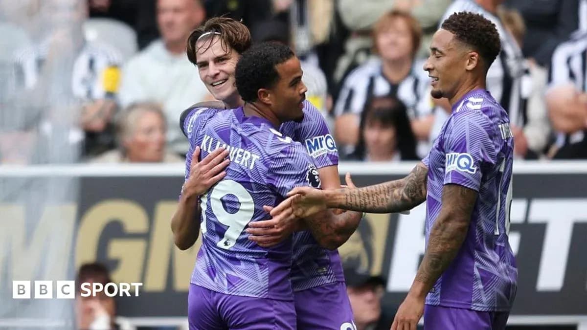 Three players celebrating a goal on the pitch