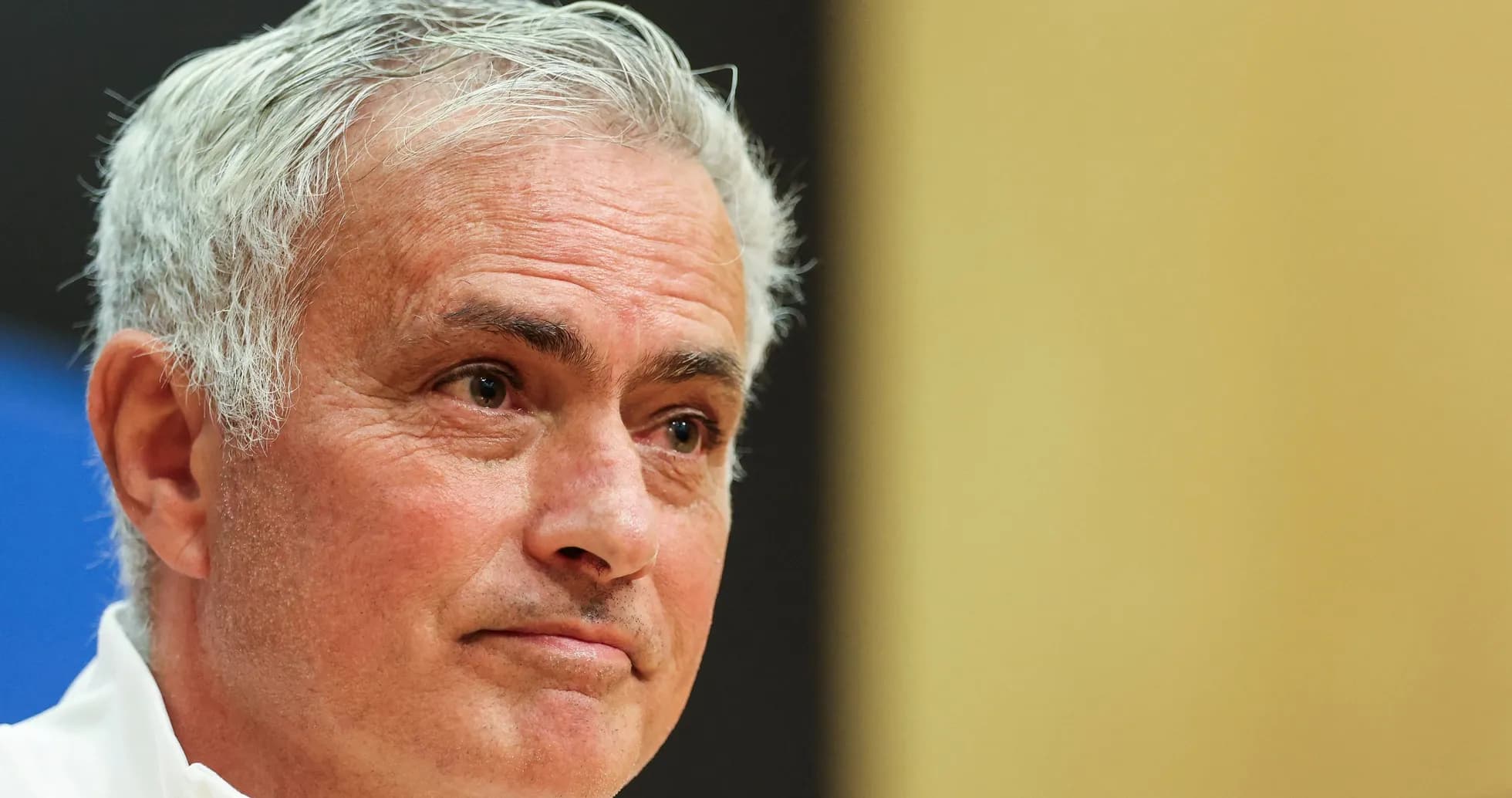 Manager speaking at press conference with serious expression