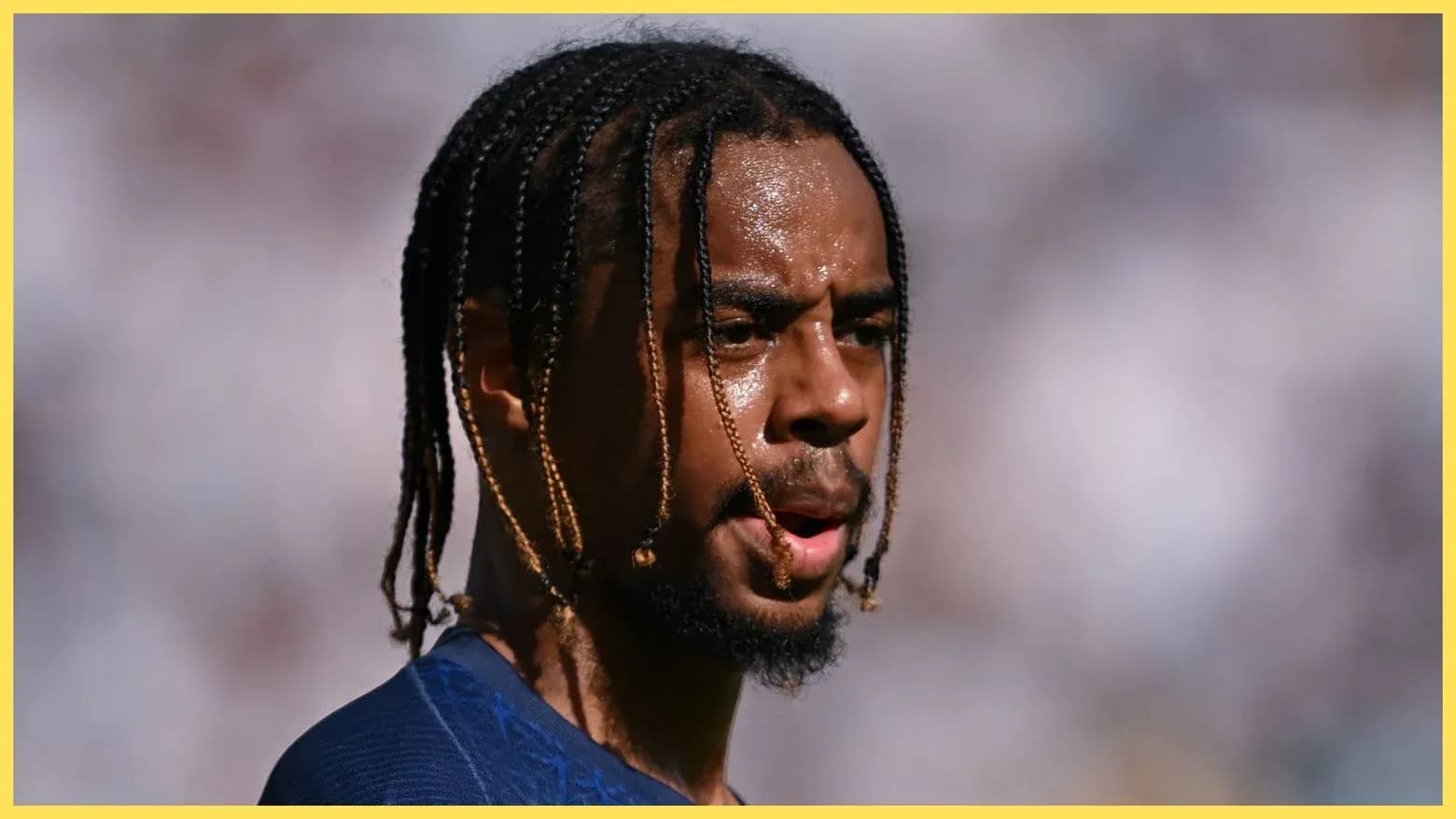 Player with braided hair during match warm-up