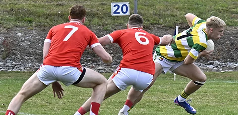 Player in green and yellow evading two red opponents