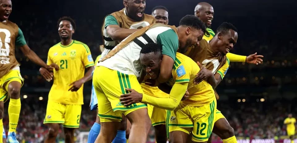 Players celebrating a goal in yellow jerseys