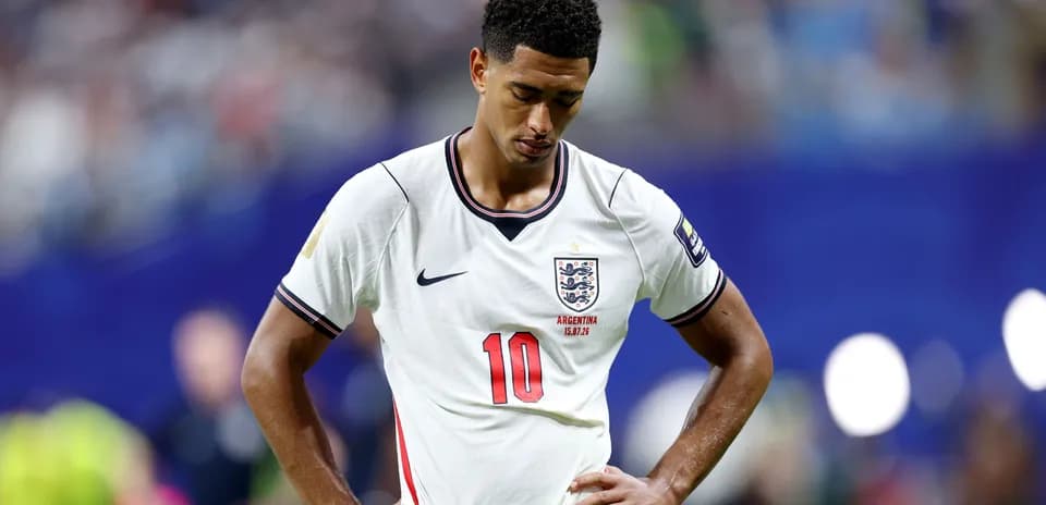 Player looking down wearing England jersey during match