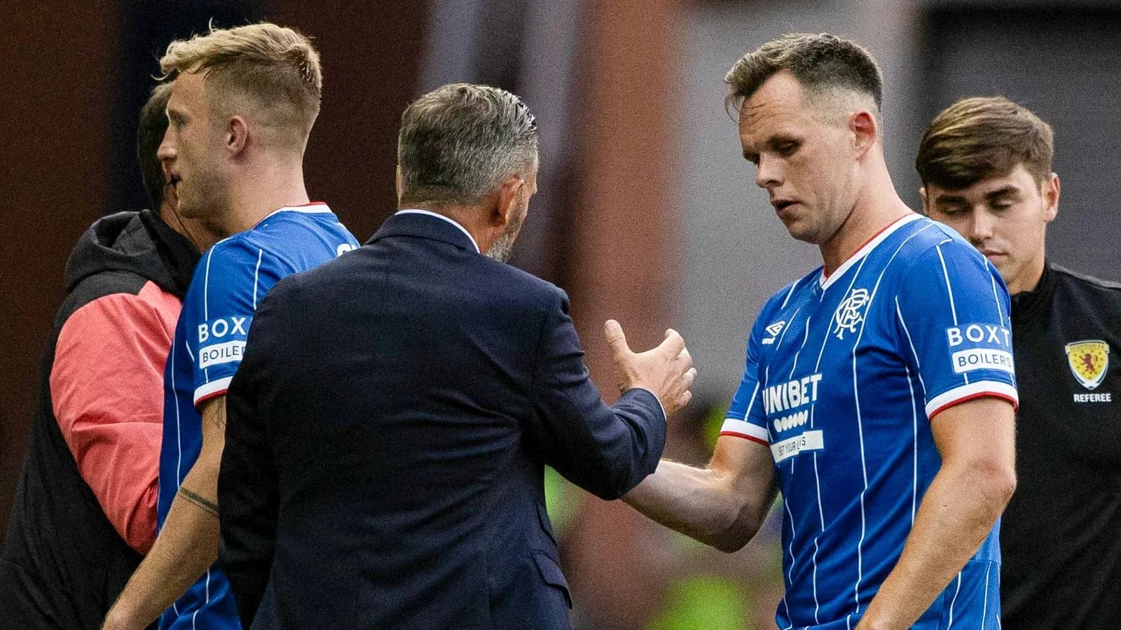 Rangers players interacting with manager during substitution