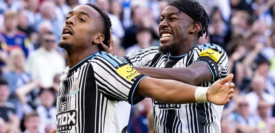 Newcastle players celebrating a goal on the pitch