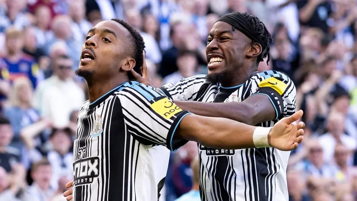 Newcastle players celebrating a goal on the pitch
