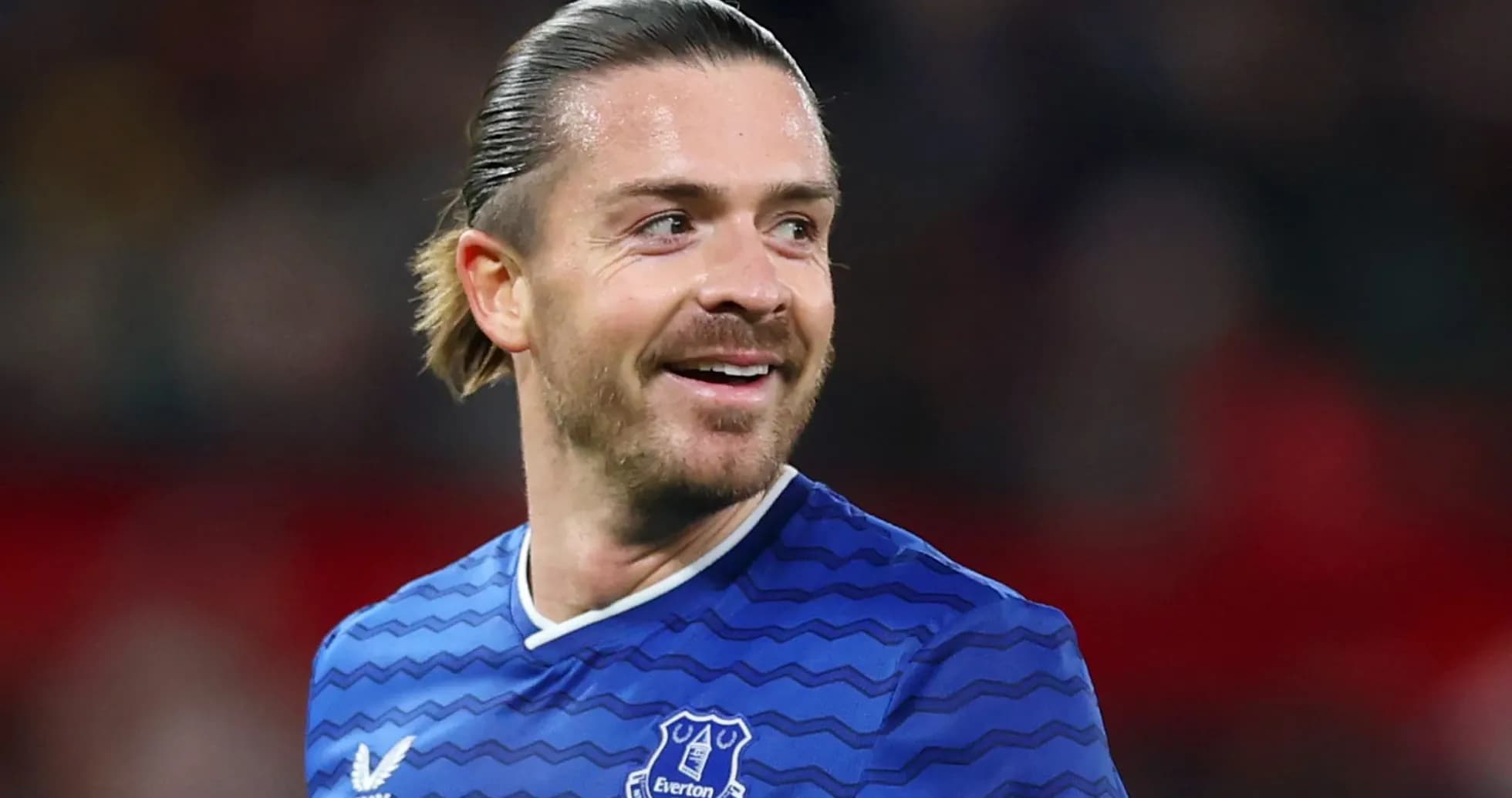 Player in blue Everton jersey smiling on field