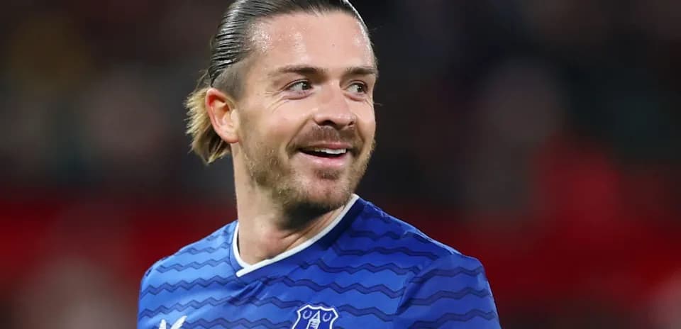 Player in blue Everton jersey smiling on field