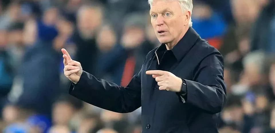 Manager gesturing during a match from the sideline