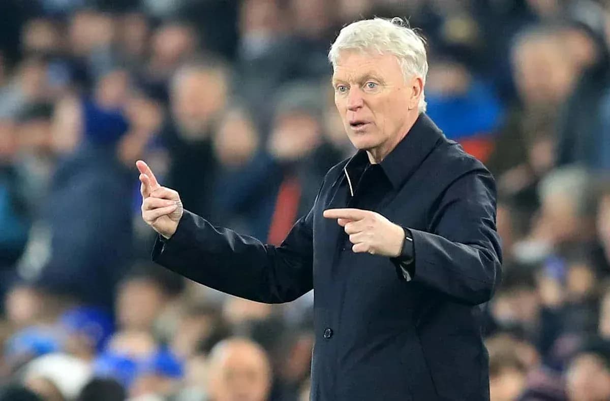 Manager gesturing during a match from the sideline