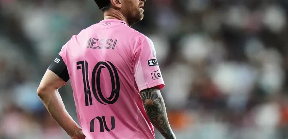Player in pink jersey looking away on field