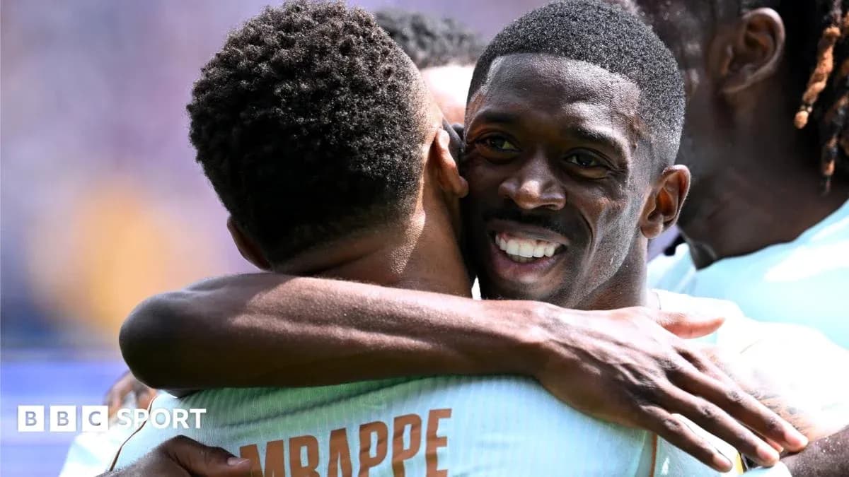 Players celebrating a goal with a hug