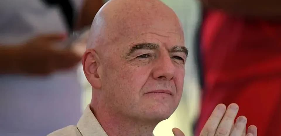 Man with bald head and clasped hands