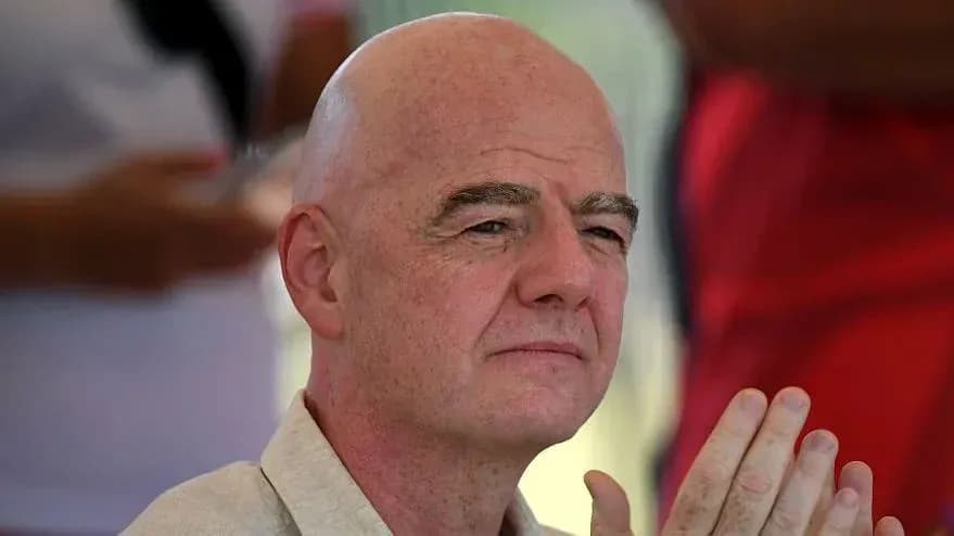 Man with bald head and clasped hands