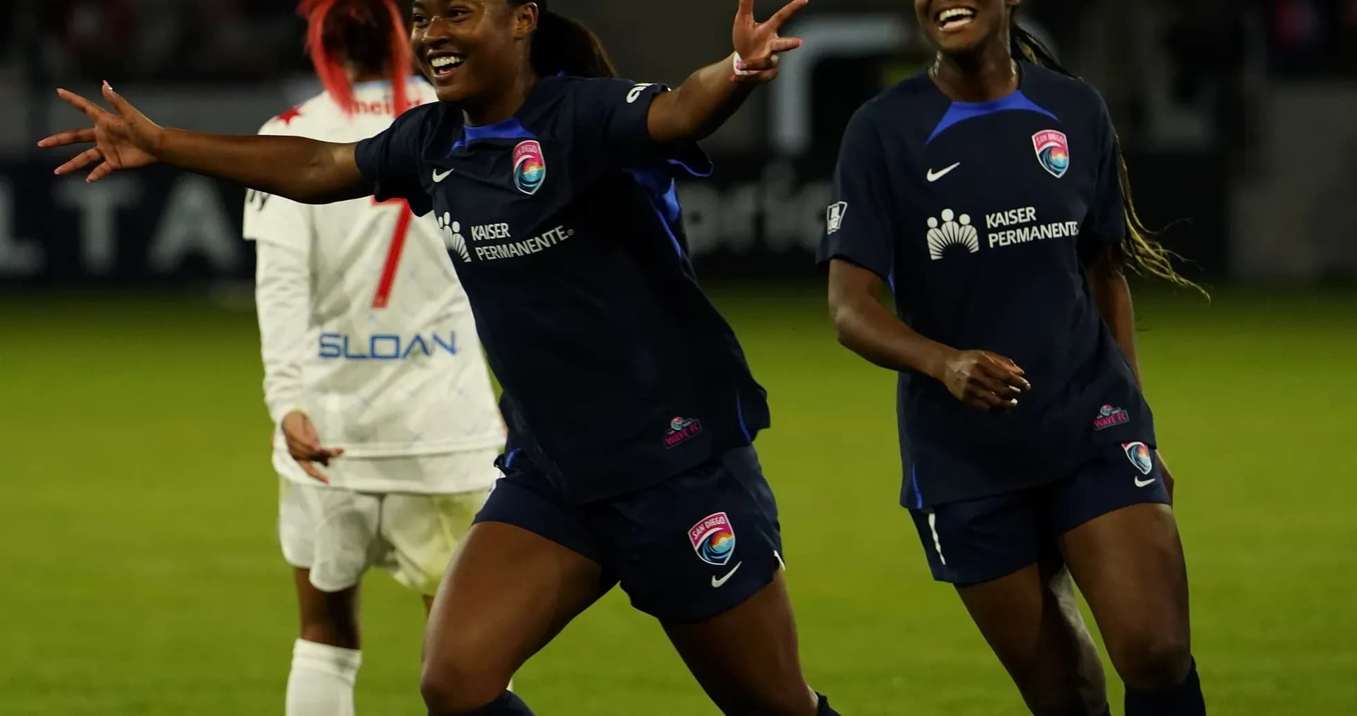 Players celebrating during NWSL match