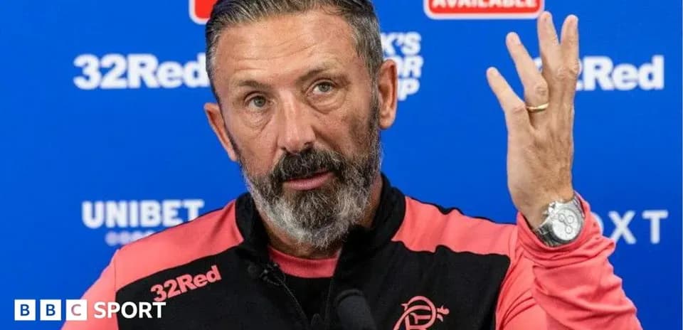 Manager speaking at press conference with hand raised