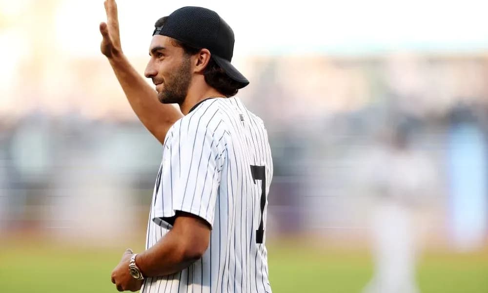 Man waving in a baseball jersey at stadium