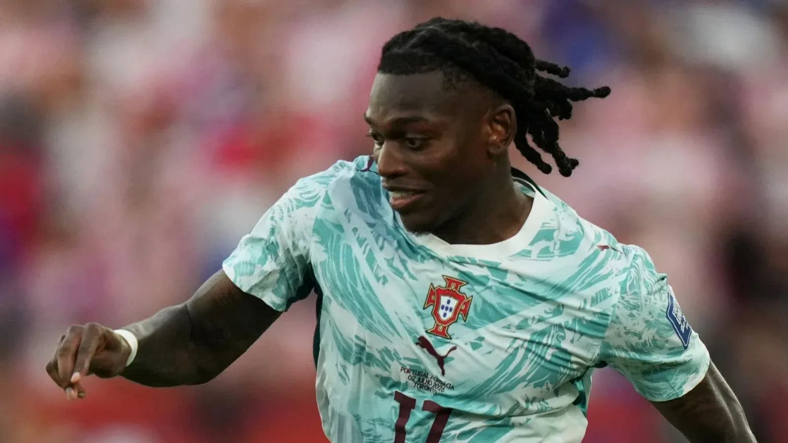 Player in Portugal kit running during match