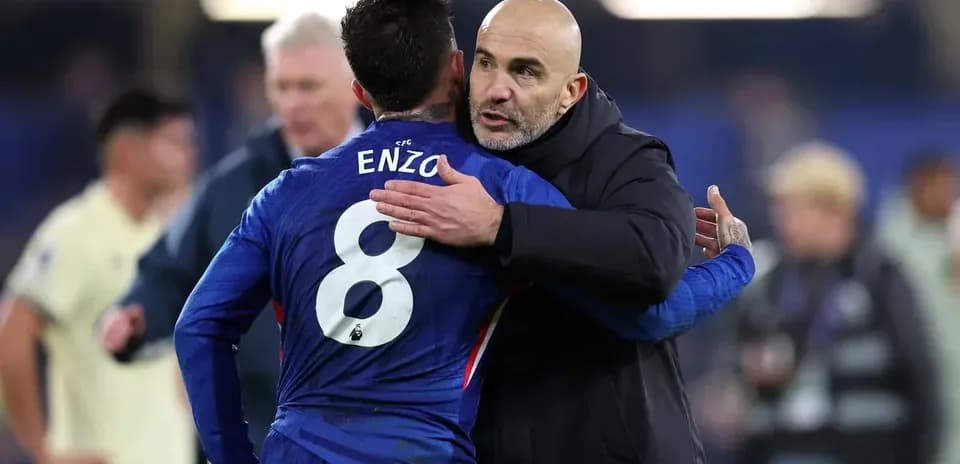 Player embracing coach after match on field